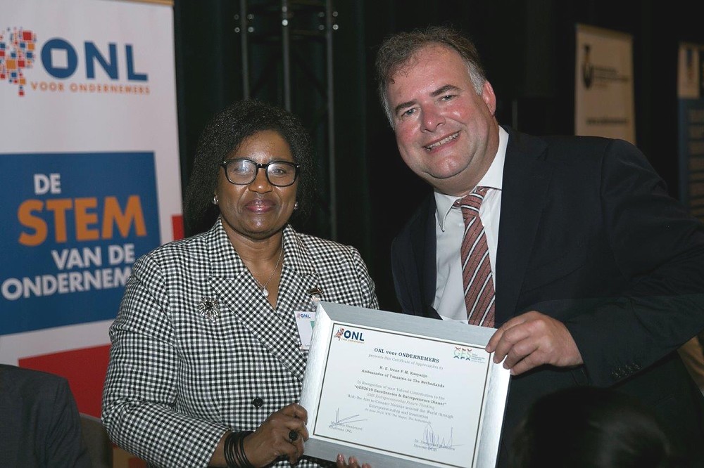 H.E Ambassador Irene Kasyanju receives certificate of appreciation for participating in the event from ONL Chairman, Mr. Hans Biesheuvel